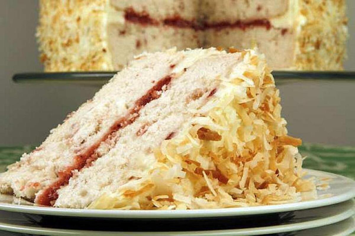 This layer cake features strawberry filling and toasted coconut on top.