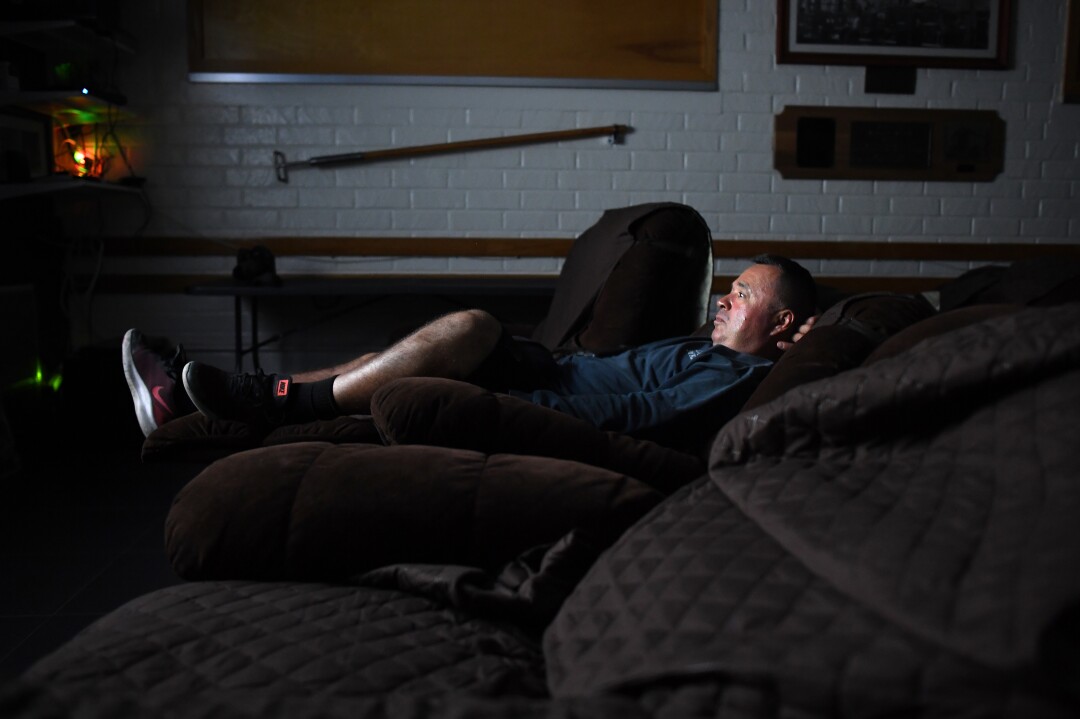 Firefighter Tony Navarro watches a movie at Fire Station No. 9