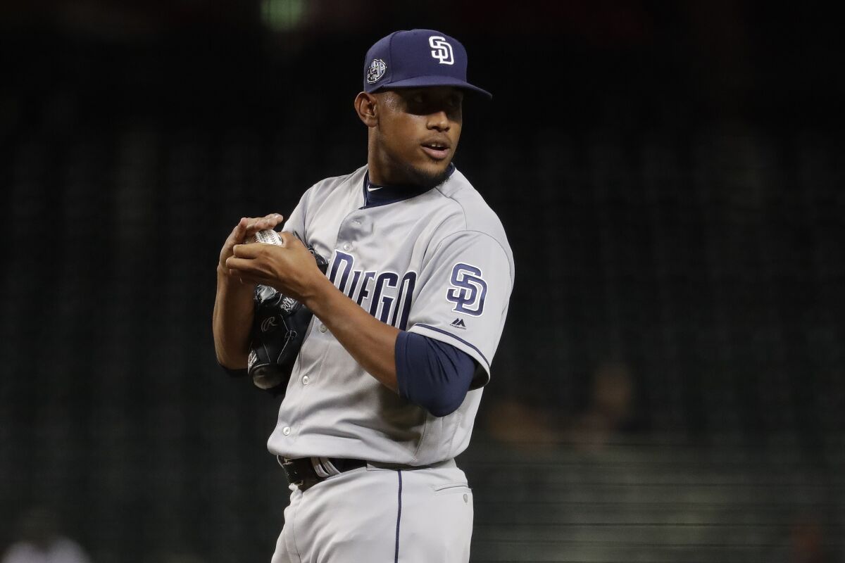 Padres starting pitcher Ronald Bolanos looks to his dugout after giving up a run against the Arizona Diamondbacks during the first inning of a baseball game, Tuesday, Sept. 3, 2019, in Phoenix.