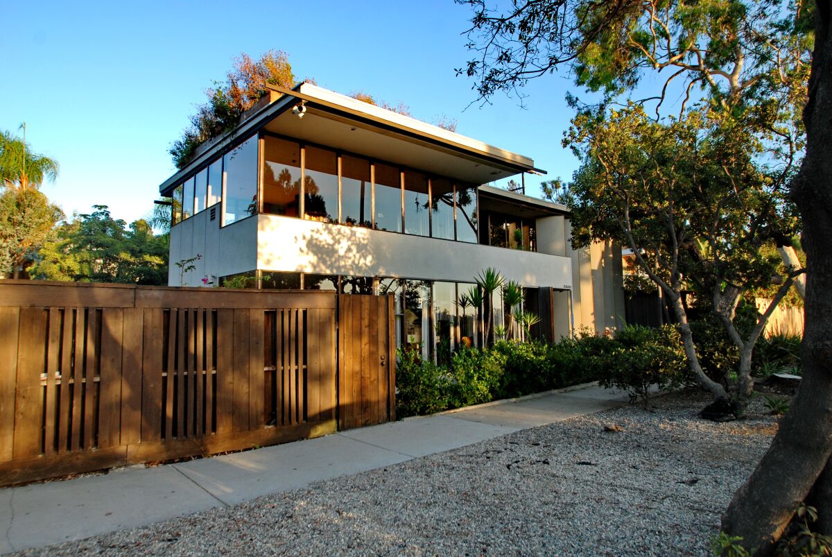A glass and wood two-story Midcentury Modern home.