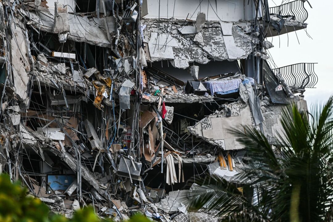 Rubble hangs from a partially collapsed building in Surfside north of Miami Beach.