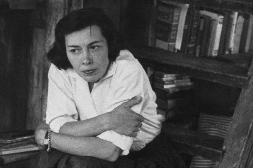 A woman in front of a bookcase.