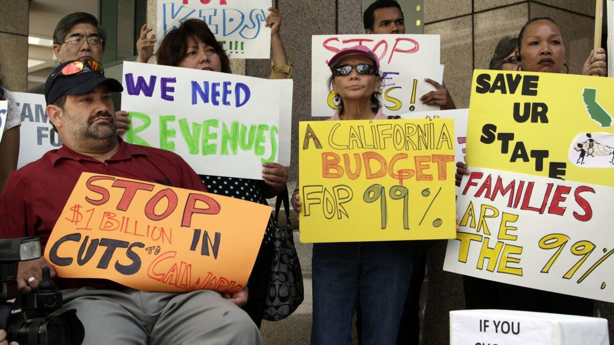 Health and human services advocates hold a Los Angeles rally to protest Gov. Jerry Brown's budget in 2014.