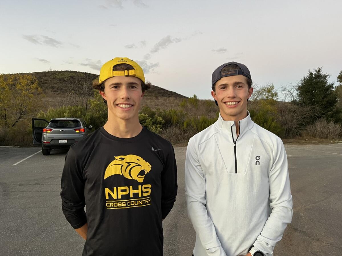 Distant runners Lex and Leo Young of Newbury Park stand side by side and smile.