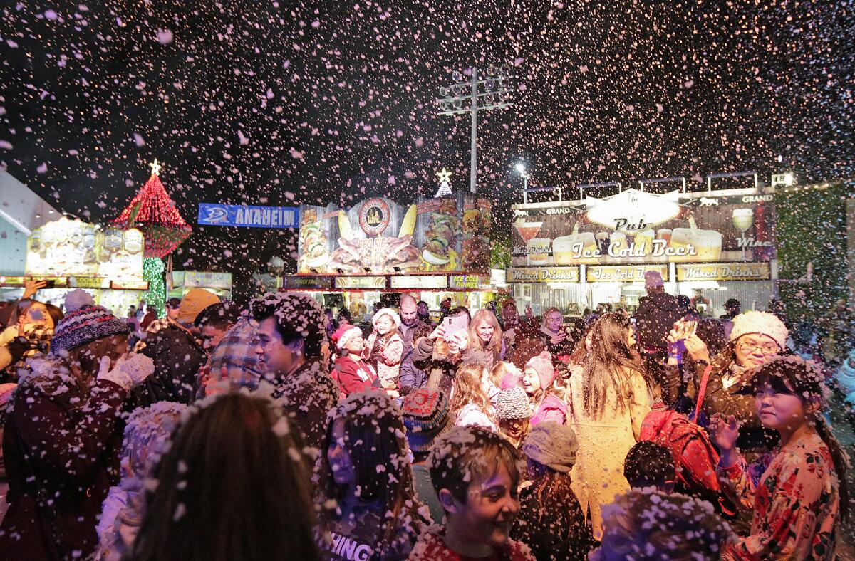 A flurry of snow — or in this case, soap bubbles — falls on guests at Winter Fest OC, which continues through Sunday at the OC Fair & Event Center in Costa Mesa.