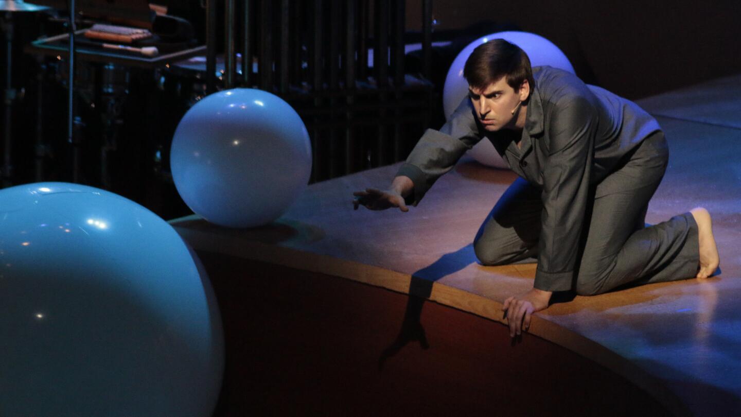 Countertenor Nathan Medley with balloons on stage performing with the L.A. Phil New Music Group conducted by John Adams in Olga Neuwirth's "Hommage a Klaus Nomi" at the Green Umbrella series concert at Walt Disney Concert Hall on Jan. 13.