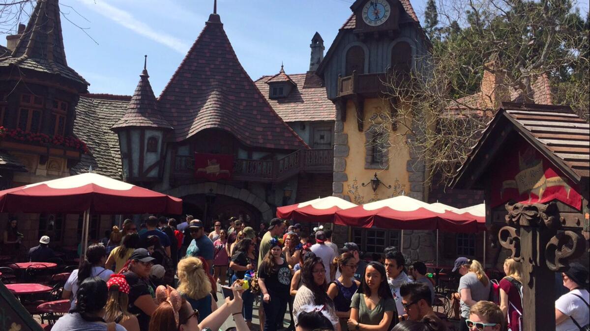 Crowds mass around the Red Rose Taverne at Fantasyland in Disneyland: Will they still be there when Trump's travel ban takes hold?