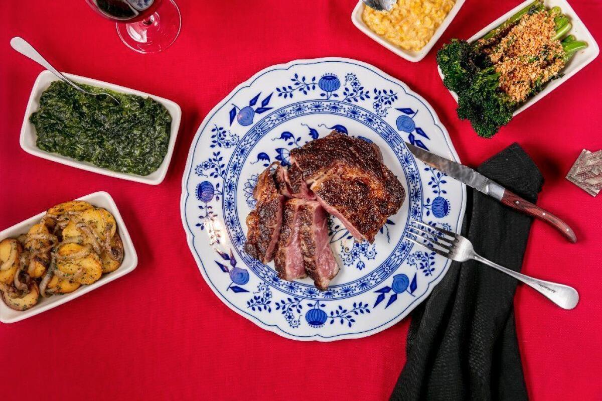 Dear John's ribeye with sides of German potatoes, creamed spinach, creamed corn and broccolini
