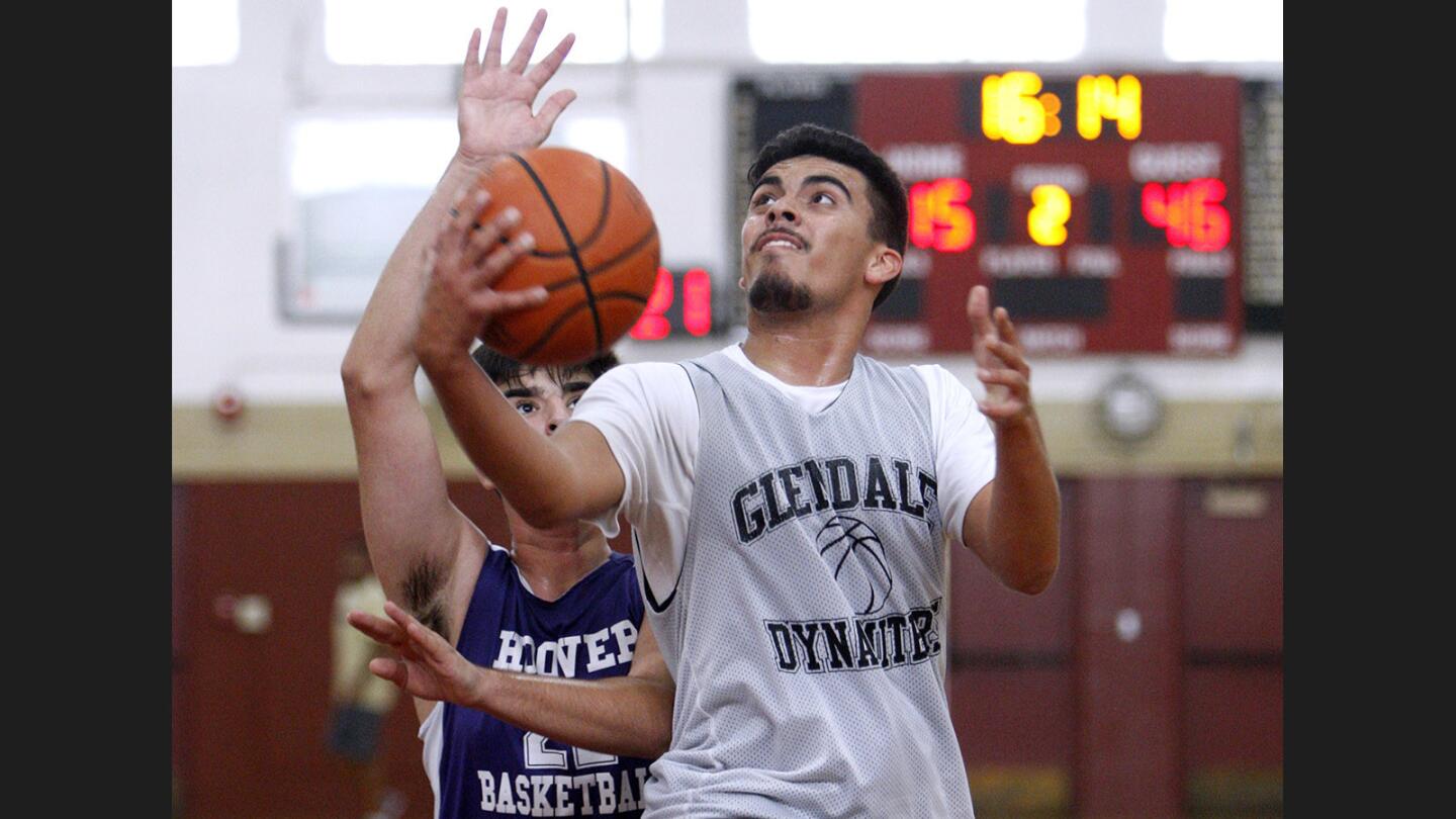 Glendale High School basketball player #44 Cesar Vargas takes it to the hoop for two in game vs. Hoover High School, in boys' Summer Basketball game at Glendale Community College in Glendale on Friday, June 23, 2017.