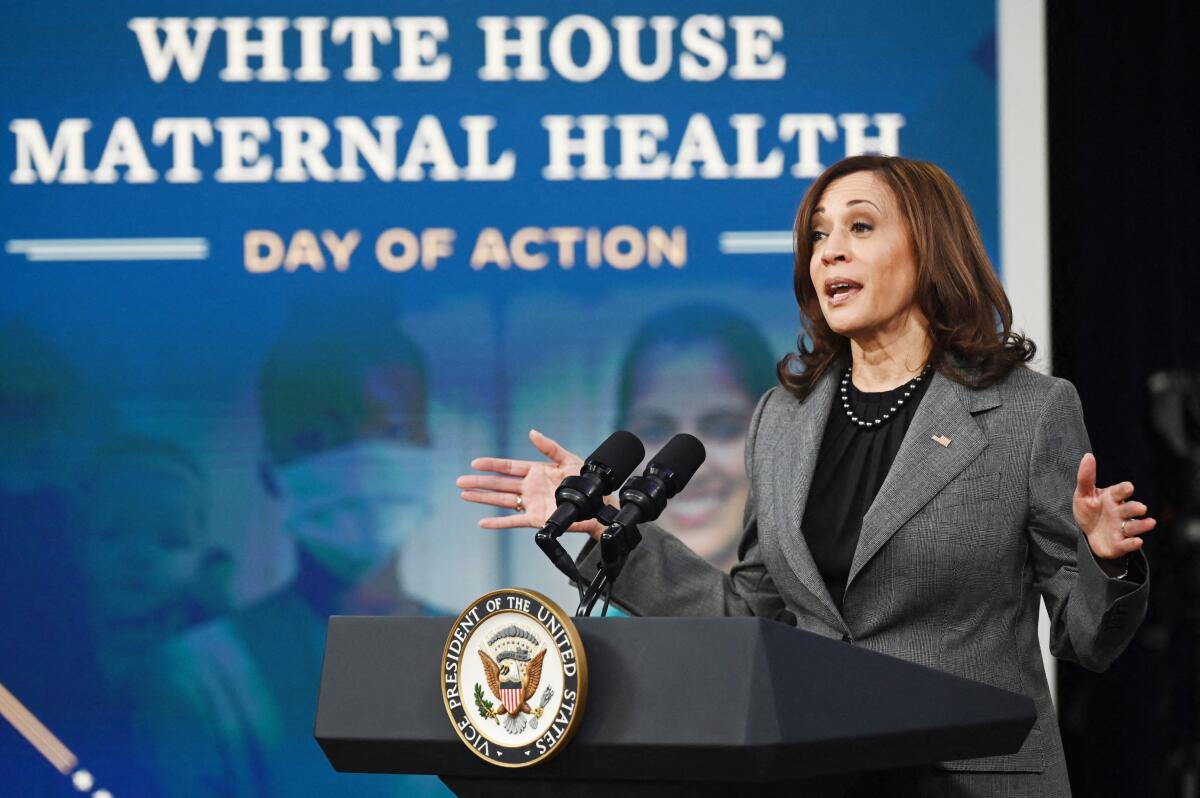 Kamala Harris speaks at a lectern with the vice presidential seal