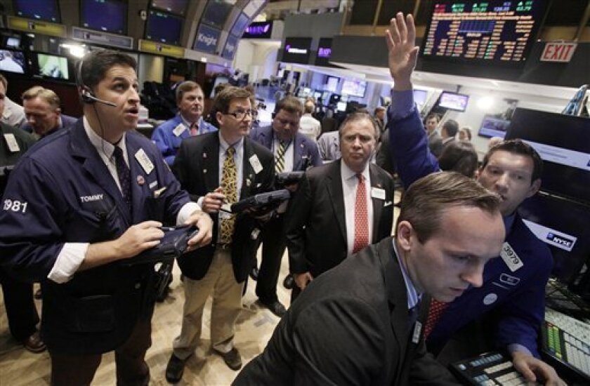 In this photo taken May 2, 2011, specialist William Bott, background right, directs trades at his post on the floor of the New York Stock Exchange. Fears of more interest rate increases in China weighed on global markets Wednesday, May 4, 2011, while the euro headed up towards 18-month highs against the dollar despite confirmation of a $115 billion bailout for Portugal(AP Photo/Richard Drew)