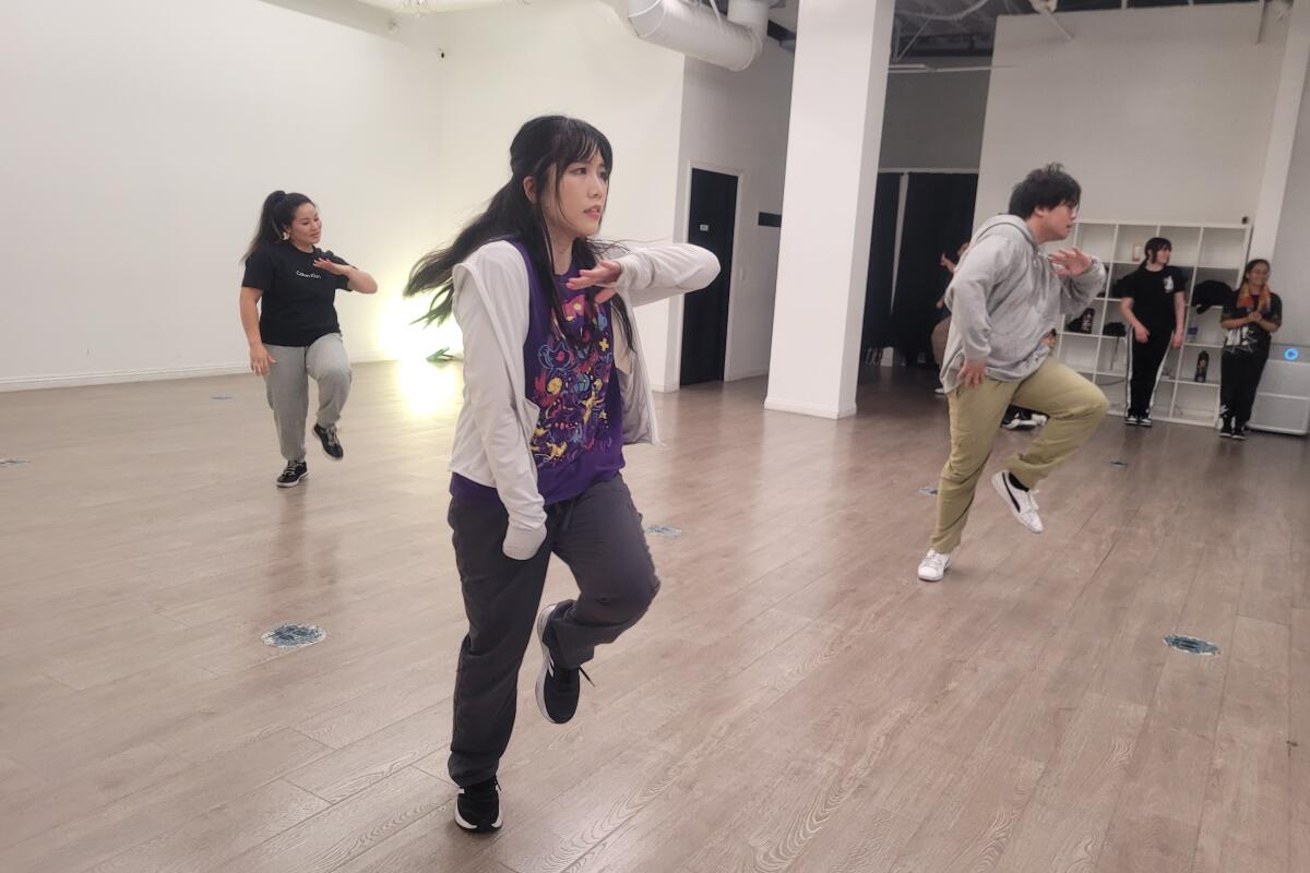 People dancing in a studio.
