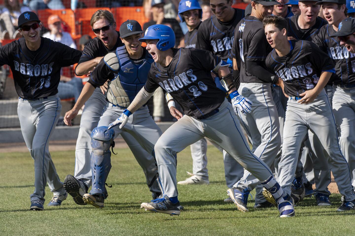 Fountain Valley's Cole Wentz is chased by his teammates back to the dugout after he hit a grand slam in the fourth inning of a Sunset League game against Huntington Beach on Wednesday, April 25.