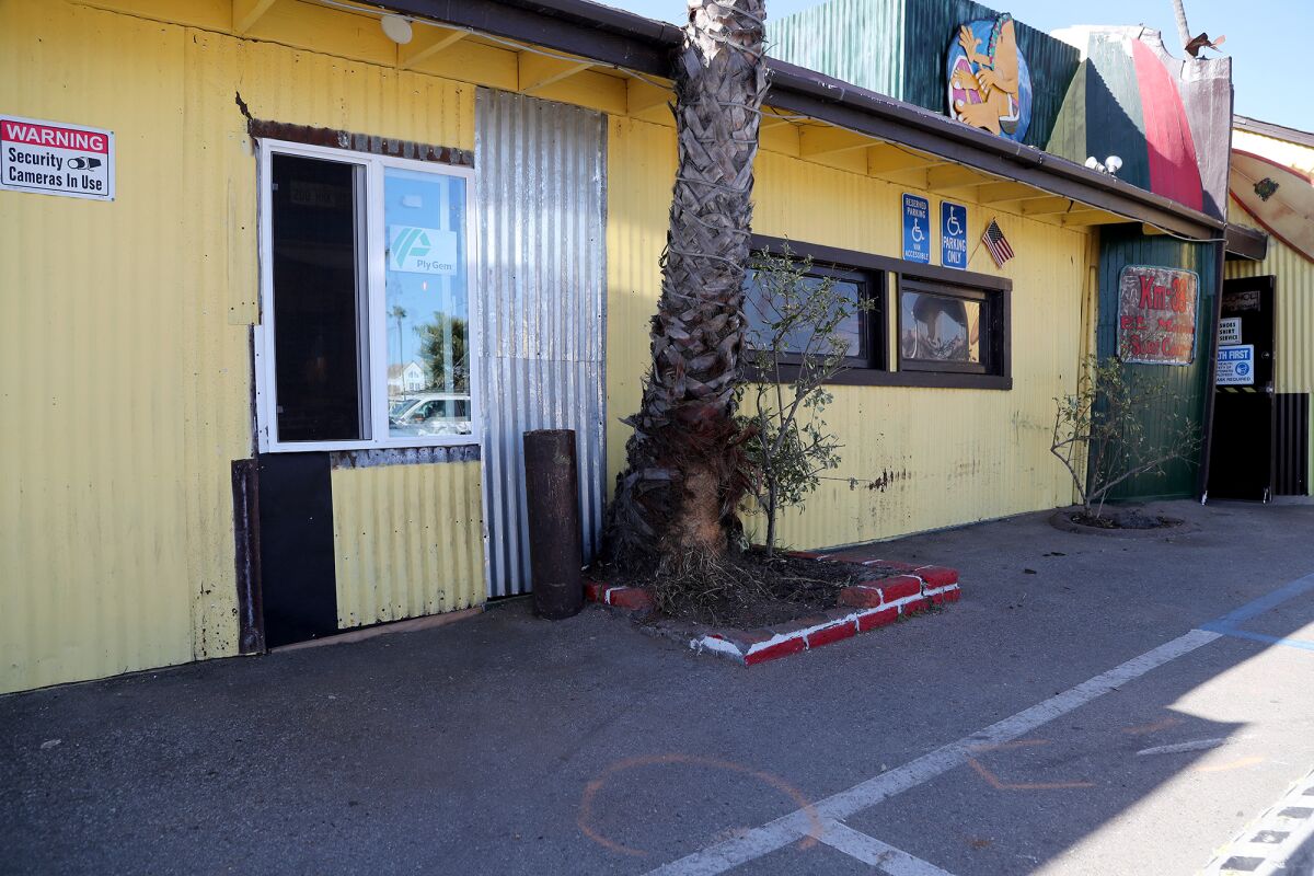 Sheet metal patches a hole caused by a vehicle that collided into the front of Taco Surf in Surfside on Sunday.