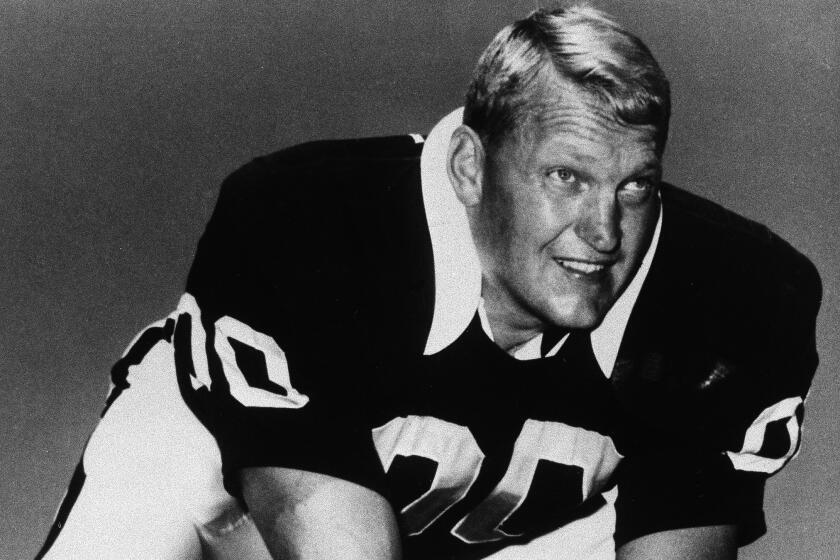 Jim Otto, offensive center of the Oakland Raiders stands in a pose to indicate he's about to snap the football