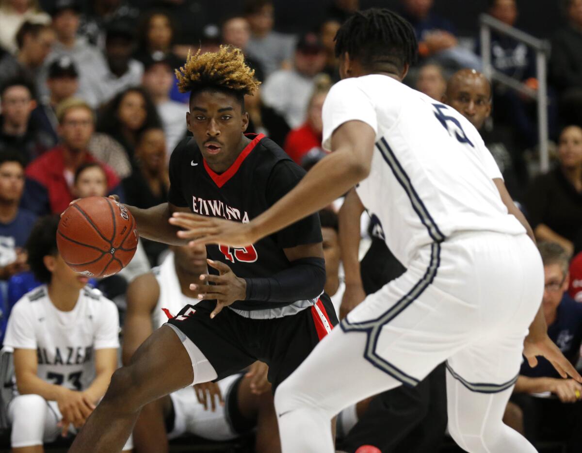 Etiwanda's Jahmai Mashack (15) attempts to drive to the basket guarded by Sierra Canyon's Terren Frank (15) in the first half of the CIF Open Division regional basketball final at the Matadome on the campus of California State University, Northridge on Tuesday.