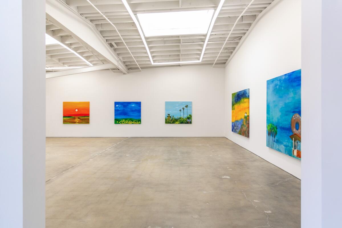 Five brightly colored paintings hang on white walls.