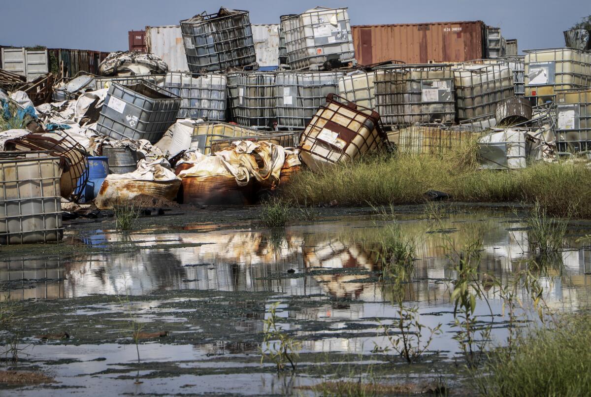 Containers used for hazardous chemicals are piled up at a junkyard near Paloch, South Sudan, in 2018.