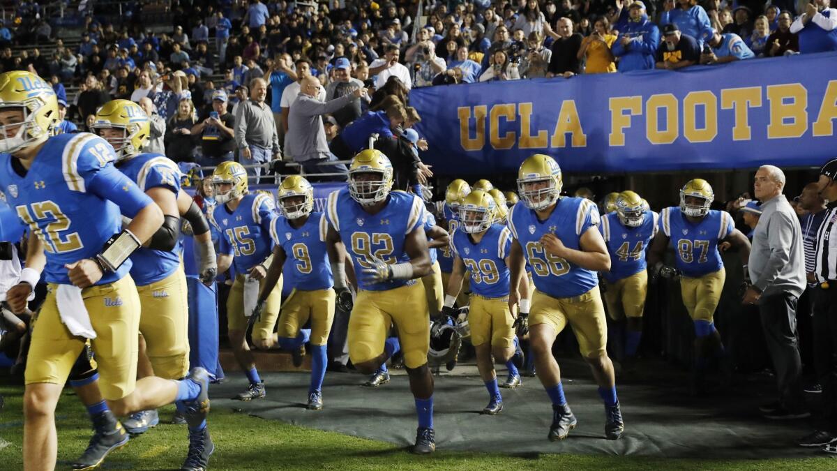 UCLA Bruins run onto the field at the Rose Bowl.