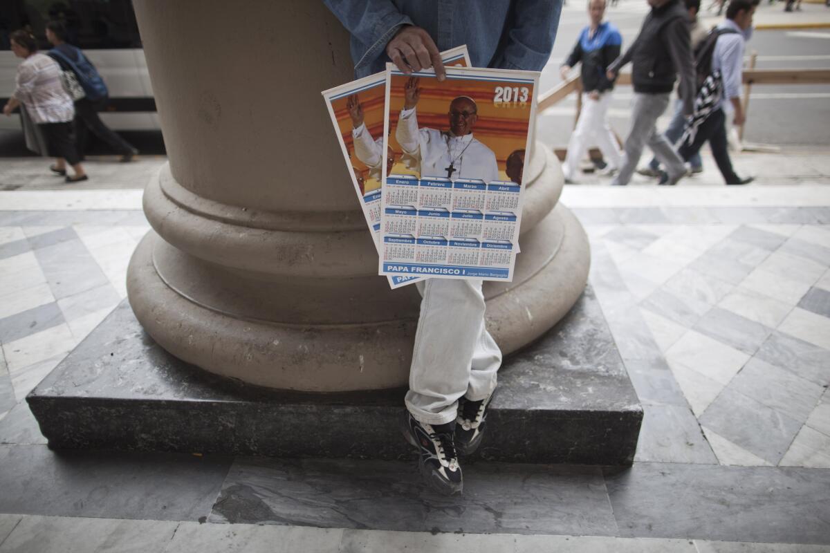 A vendor sells calendars featuring Pope Francis outside the Metropolitan Cathedral in Buenos Aires.