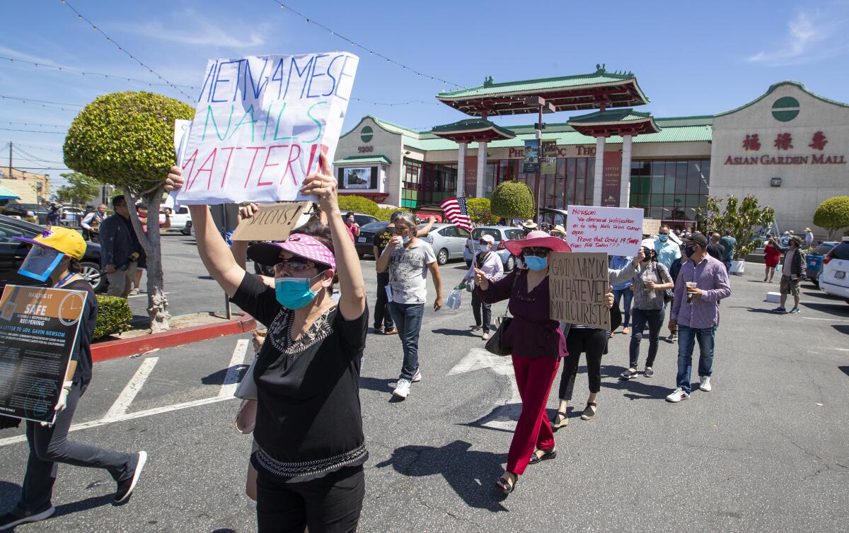 Protesters asking Gov. Newsom to #OpenNailSalonsNow march around Little Saigon on Monday.