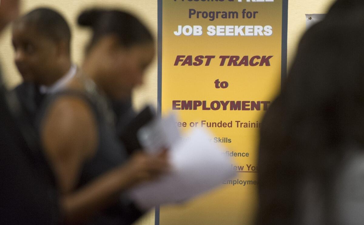 The number of job openings in September reached 3.9 million, a five-year high. Above, job seekers talk to recruiters at an Atlanta job fair earlier this year.