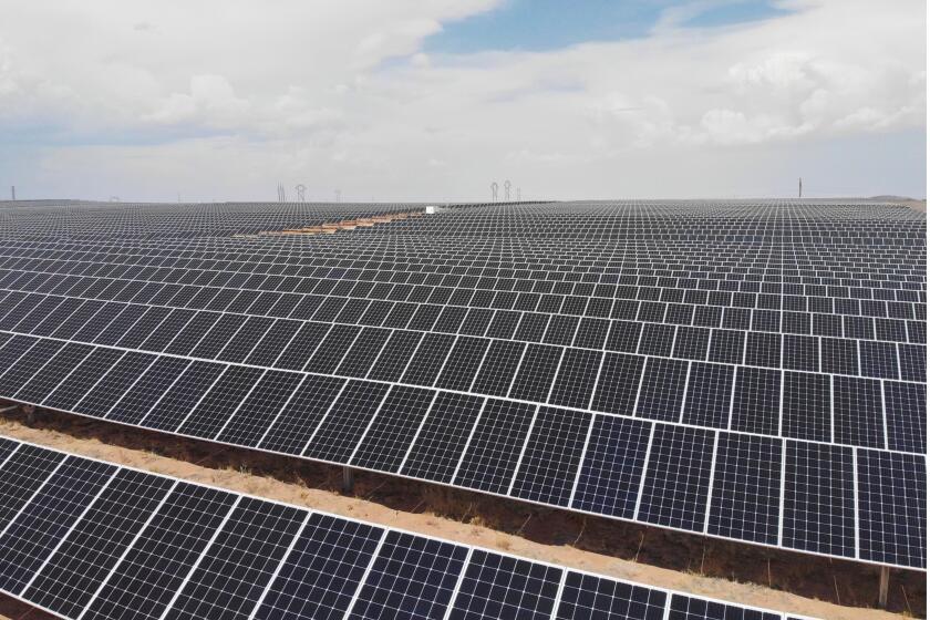 FILE - A solar farm is seen west of Rio Rancho, N.M., on June 15, 2021. Singapore-based Maxeon Solar Technologies plans to build a major solar panel manufacturing plant in Albuquerque, pending approval of a loan application with the U.S. Department of Energy, the company announced Thursday, Aug. 10, 2023. (AP Photo/Susan Montoya Bryan, File)