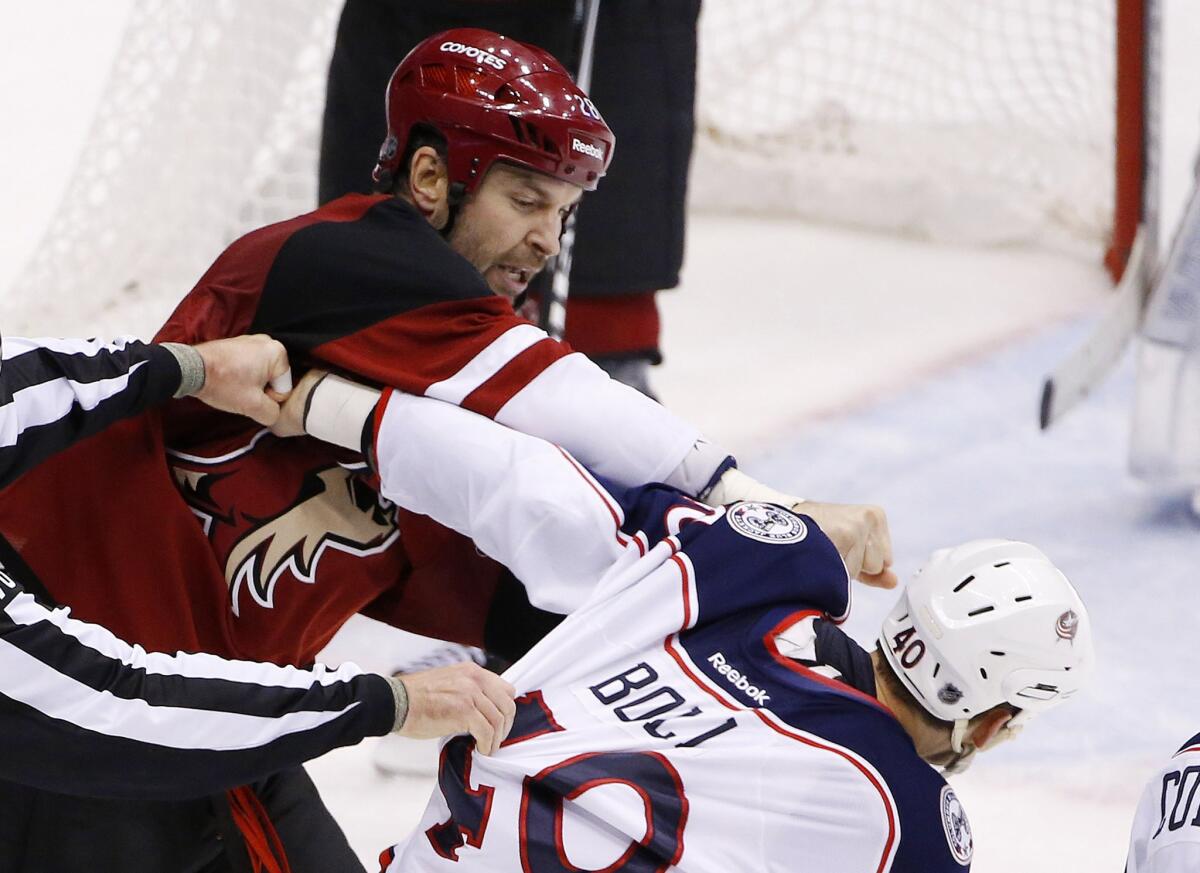 Coyotes enforcer John Scott, left, punches the Blue Jackets' Jared Boll (40) during a fight on Dec. 17, 2015.