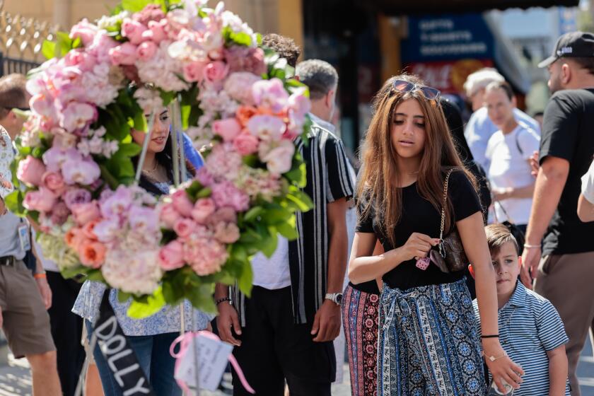 Los Angeles, CA - August 25, 2026: Fans mourn Dolly Parton at Parton's star on the Hollywood Walk of Fame on Tuesday, Aug. 25, 2026, in Los Angeles, CA. Parton, an American icon and one of the most famous country artists, passed away at the age of 80 today. (Arwen Clemans/Los Angeles Times)
