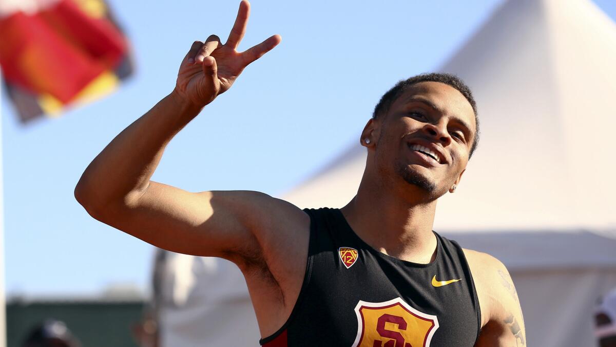 USC's Andre De Grasse celebrates after winning the men's 200 meters at the NCAA track and field championships in Eugene, Ore., on Friday