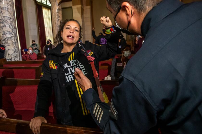 Los Angeles , CA - January 17: Black Lives Matter co-founder Melina Abdullah protests the presence of city council Kevin de Leon at the city council meeting at City Hall on Tuesday, Jan. 17, 2023 in Los Angeles , CA. (Irfan Khan / Los Angeles Times)