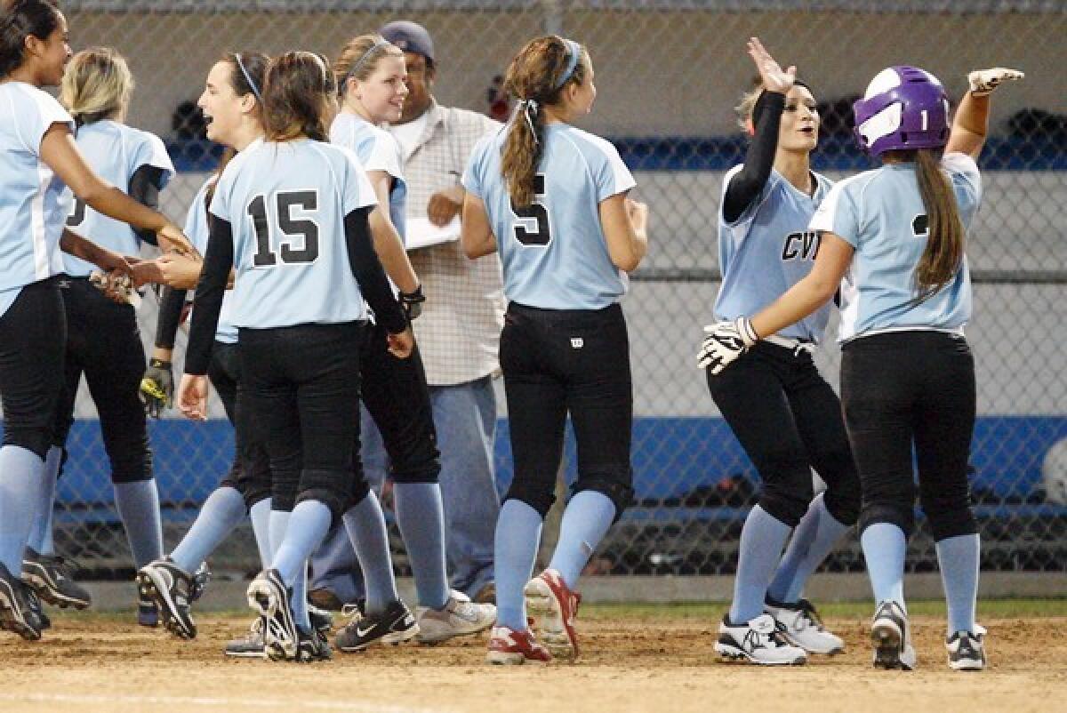 Calley Ellingford, second from right, gives Alex Howard a high five after the Crescenta Valley-Foothill All-Star Junior softball team beat Westchester Del Rey at Kent D. Face Field in Westchester on Thursday.