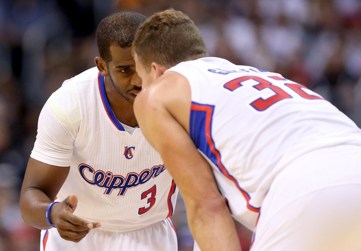 Chris Paul talks with Blake Griffin during a game against the Denver Nuggets on April 15.
