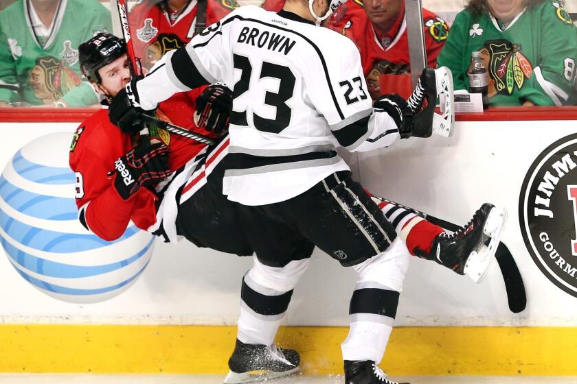 Kings captain Dustin Brown levels Blackhawks left wing Bryan Bickell with a hit along the boards in the first period of Game 1 on Saturday.