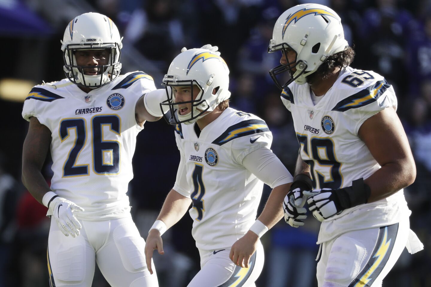 Chargers kicker Michael Badgley celebrates with teammates Casey Hayward Jr., left, and Sam Tevi after converting a 53-yard field goal during the first quarter.