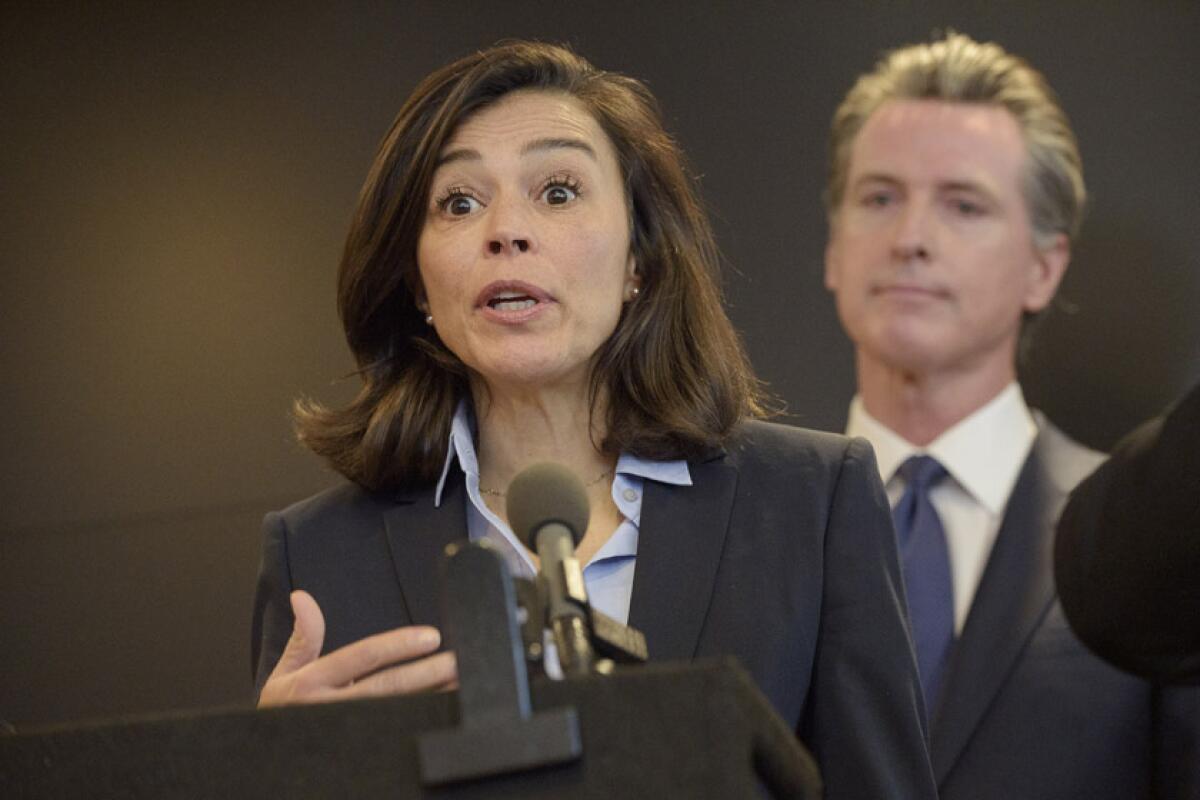 Dr. Sonia Angell is joined by California Gov. Gavin Newsom during a news conference on Feb. 27.