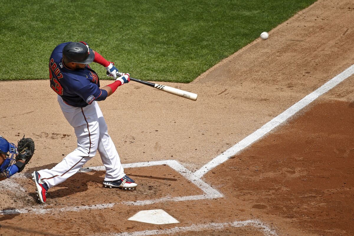 Minnesota Twins' Nelson Cruz hits a two run homer against the Kansas City Royals in the third inning of game one of a baseball double-header Saturday, Aug. 15, 2020, in Minneapolis. (AP Photo/Bruce Kluckhohn)