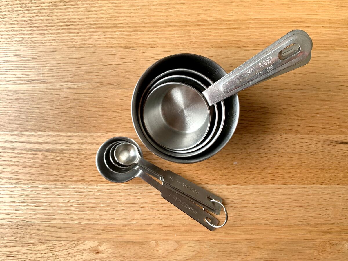 Sets of graduated dry measuring cups and spoons.