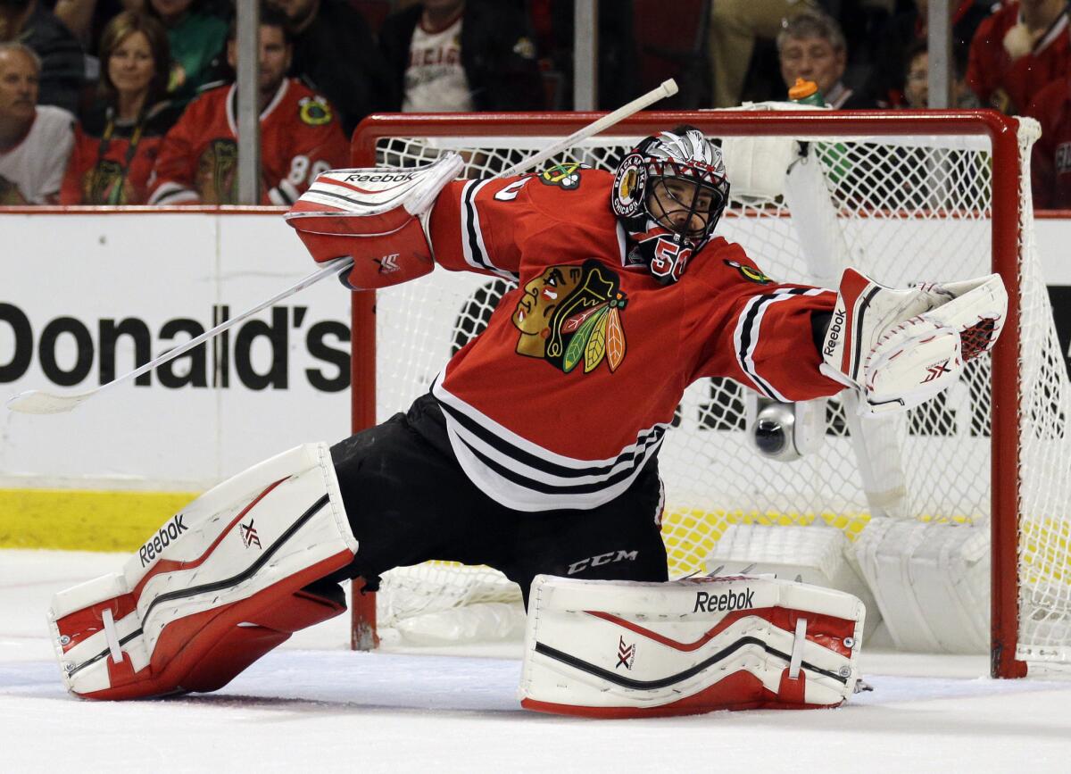 Chicago Blackhawks goalie Corey Crawford makes a glove save on a shot during the third period of Game 4 of the Western Conference finals against the Anaheim Ducks.