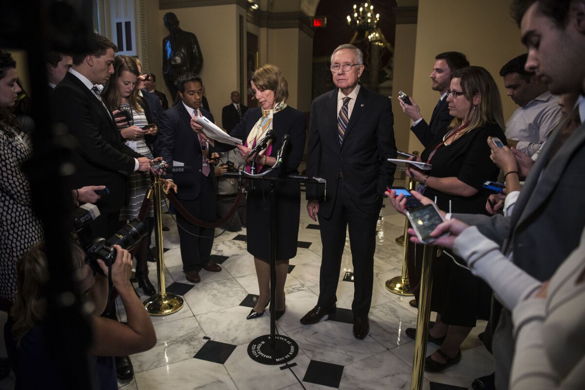 But who got left behind? House Minority Leader Nancy Pelosi and Senate Minority Leader Harry Reid take bows after the congressional budget deal was reached last week.