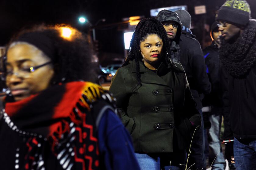 Activist Johnetta Elzie, 25, stands outside the Ferguson, Mo., police station during a demonstration.