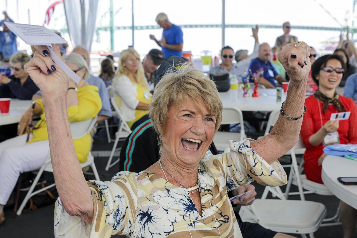Dottie Blietz, 81, sings the traditional "Iowa Corn Song" on the deck of the battleship Iowa.