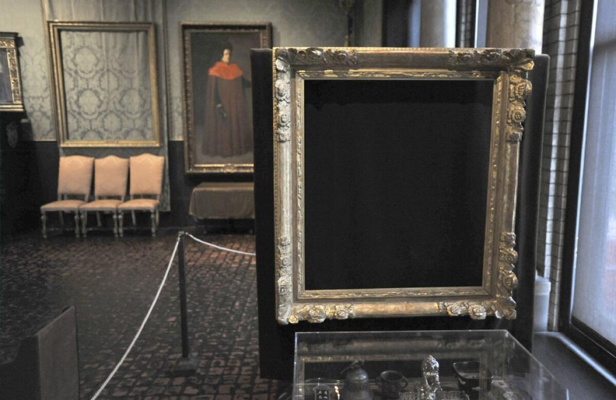 Empty frames from which thieves took "Storm on the Sea of Galilee," left background, by Rembrandt, and "The Concert," right foreground, by Vermeer, remain on display at the Isabella Stewart Gardner Museum in Boston.