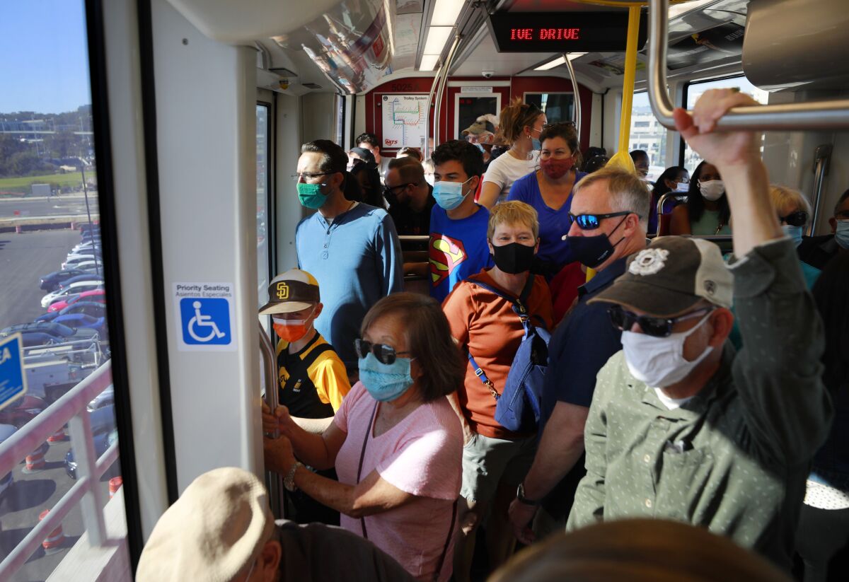 People ride the Mid-Coast Extension of the UC San Diego Blue Line Trolley during its grand opening Nov. 21.