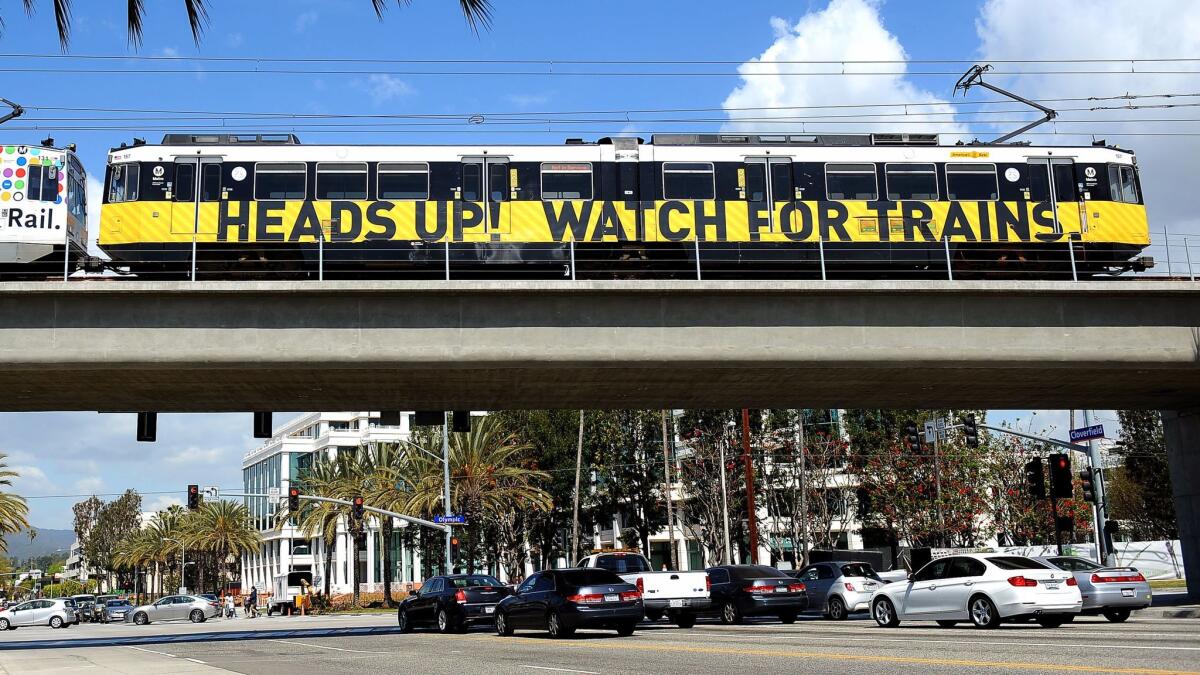 A train crosses a bridge to the 26th Street/Bergamot station in Santa Monica.