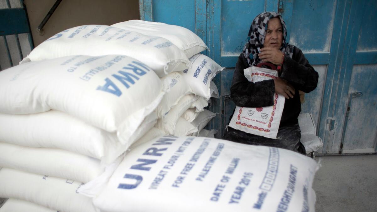 A Palestinian refugee waits to receive aid at a distribution center of the United Nations Relief and Works Agency in the southern Gaza Strip town of Khan Younis.