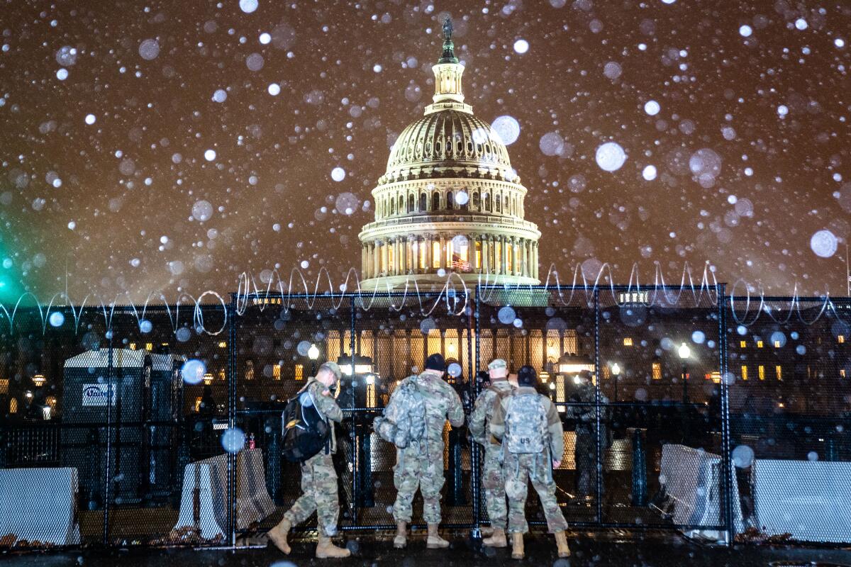Snow falls on the U.S. Capitol grounds on Wednesday.