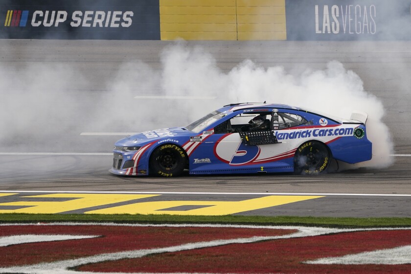 Kyle Larson does a burnout after winning a NASCAR Cup Series auto race Sunday, March 7, 2021, in Las Vegas. (AP Photo/John Locher)
