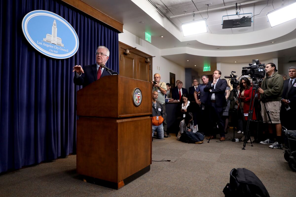 Los Angeles City Council President Paul Krekorian stands at a podium.