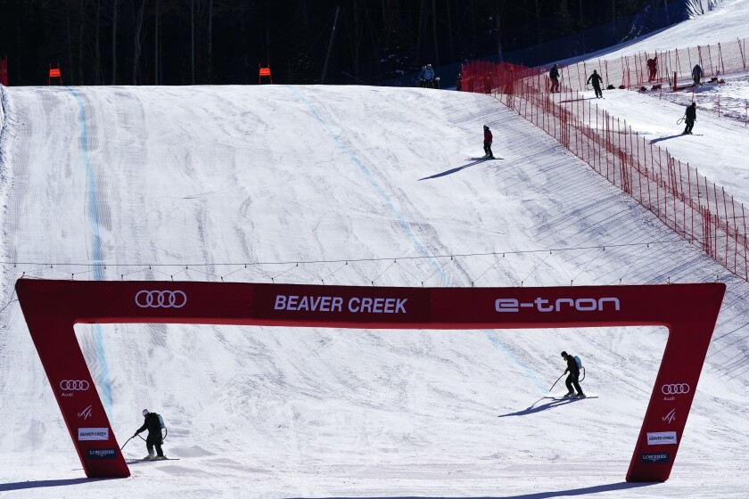 Workers prepare the finish of the Birds of Prey course, Tuesday, Nov. 30, 2021, in Beaver Creek, Colo., for the men's World Cup ski race. (AP Photo/Gregory Bull)
